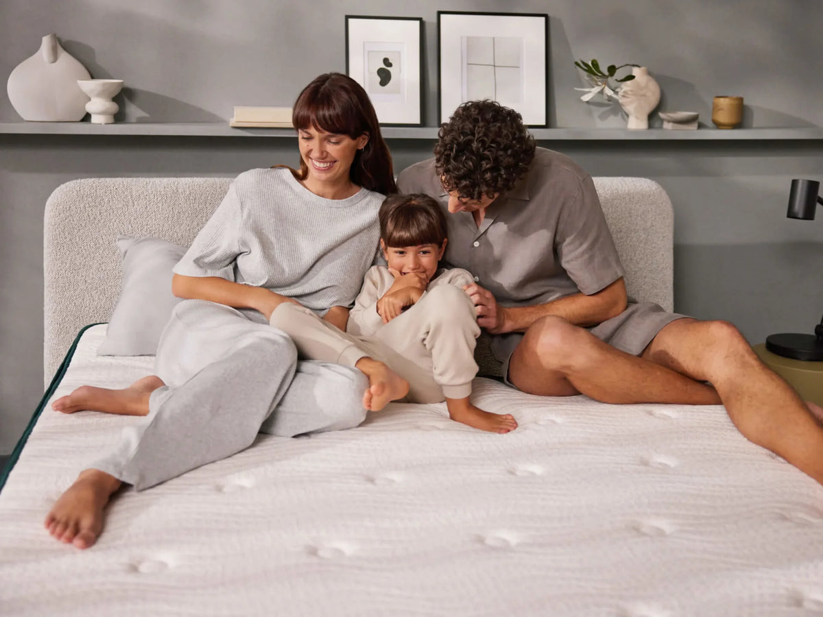 Family relaxing together on the NOCTE Performance Mattress in a modern bedroom